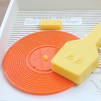 A custom Star Wars record being played on a Fisher Price toy record player from the 70's.