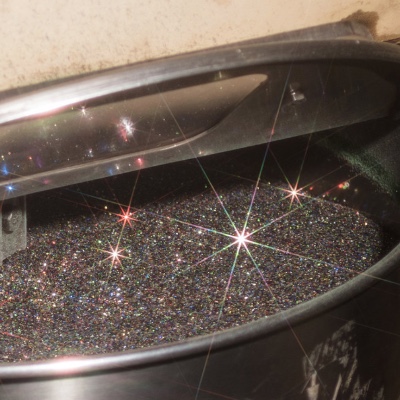 A container of glitter at a glitter factory.